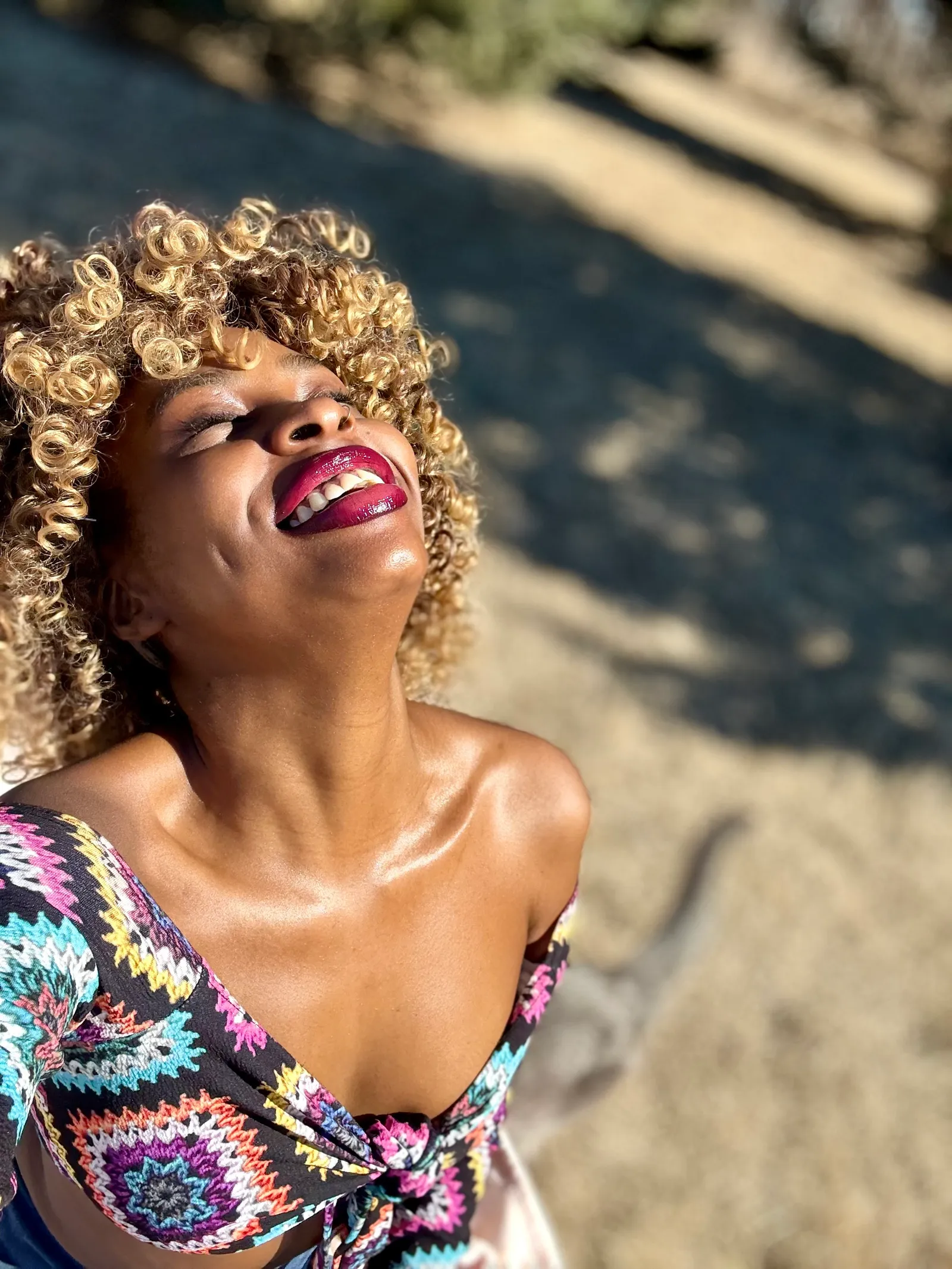 Ashlure editorial portrait: model laughing in the sunlight